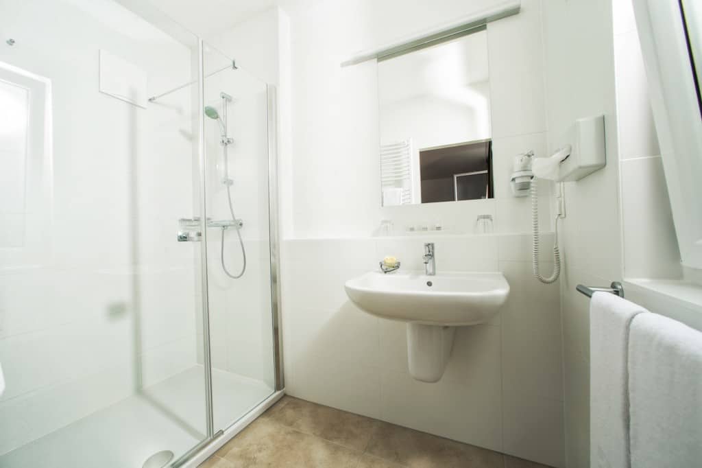 Bright, clean hotel bathroom with shower, sink, and amenities for a comfortable stay.